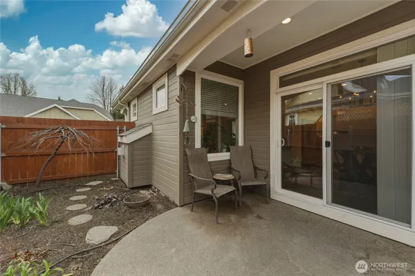 a view of a patio with chair and tables