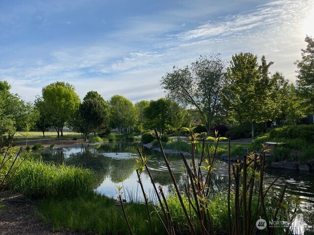764 Southeast Quail Run College Place, WA 99324 - Photo 28 of 40 a view of a lake with a house in the background