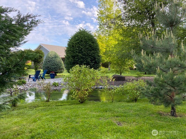 764 Southeast Quail Run College Place, WA 99324 - Photo 30 of 40 a view of a garden with a fountain