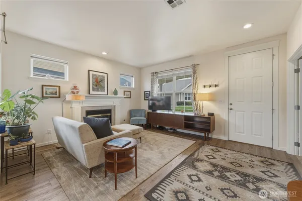 a living room with furniture and a fireplace