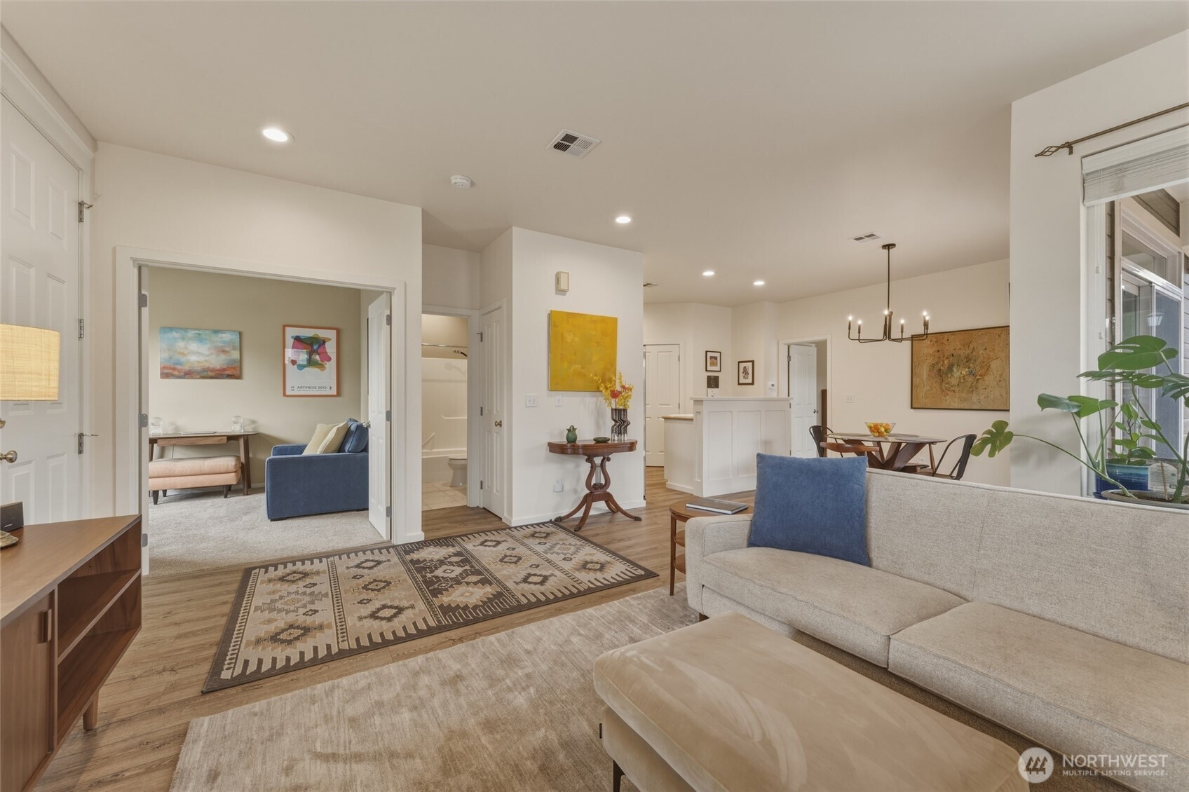 764 Southeast Quail Run College Place, WA 99324 - Photo 6 of 40 a living room with furniture a rug and kitchen view