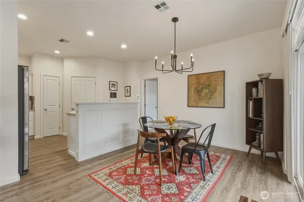 a view of a dining room with furniture and wooden floor