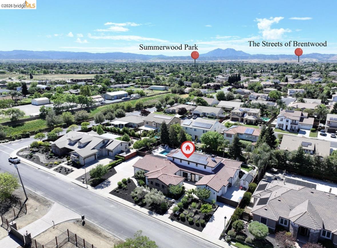 1605 Lone Oak Road Brentwood, CA 94513 - Photo 3 of 55 an aerial view of a city with lots of residential buildings and mountain view in back
