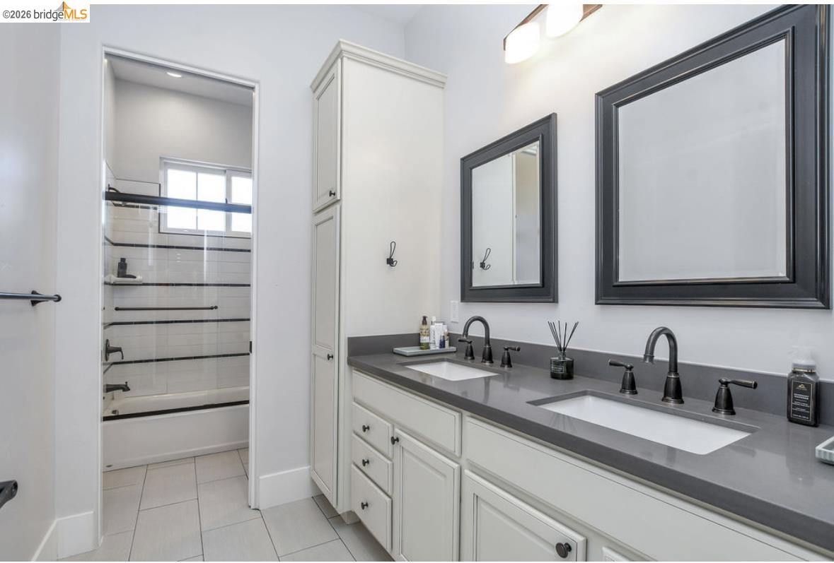 1605 Lone Oak Road Brentwood, CA 94513 - Photo 30 of 55 a bathroom with a double vanity sink and mirror