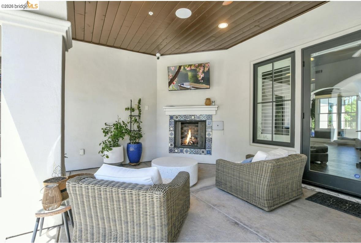 1605 Lone Oak Road Brentwood, CA 94513 - Photo 34 of 55 a living room with furniture a chandelier and a fireplace