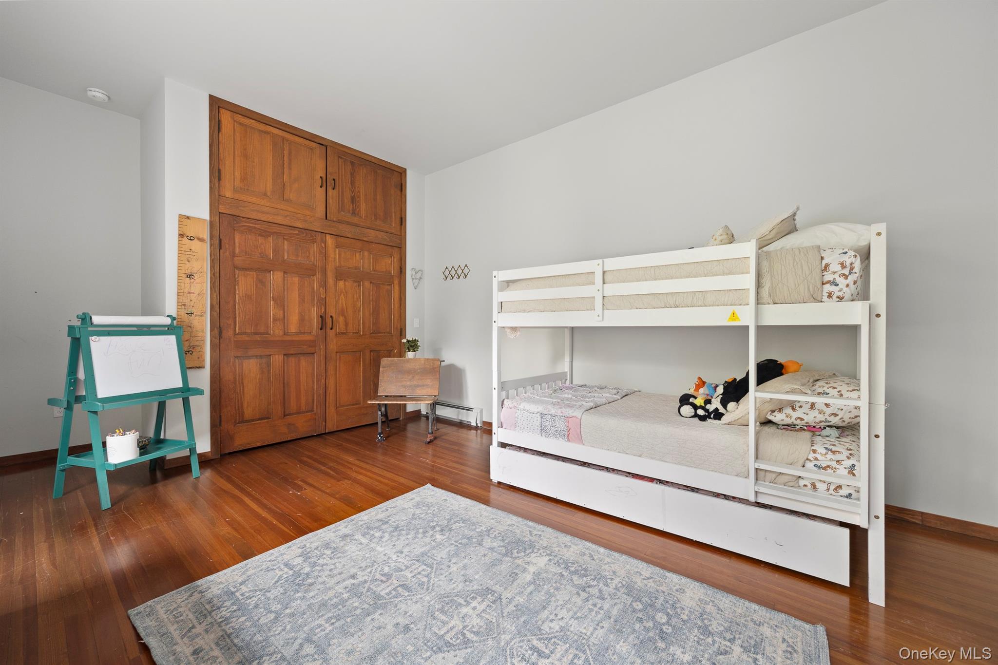 4 Clove Branch Road Hopewell Junction, NY 12533 - Photo 16 of 32 a bedroom with a bed and a wooden floor