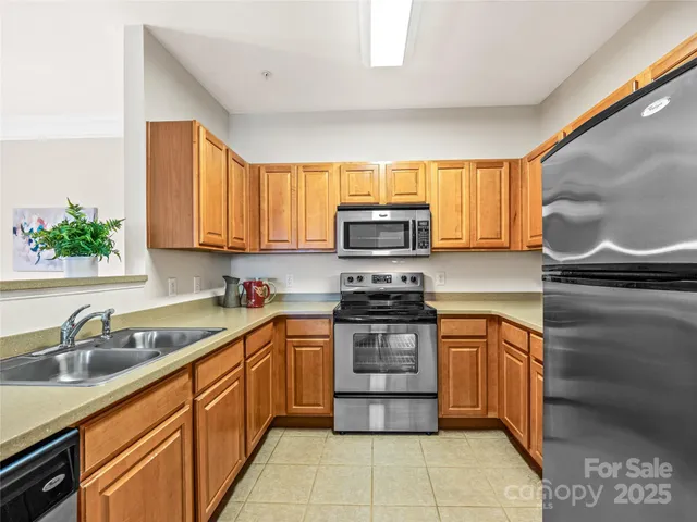 a kitchen with stainless steel appliances granite countertop a sink stove and microwave