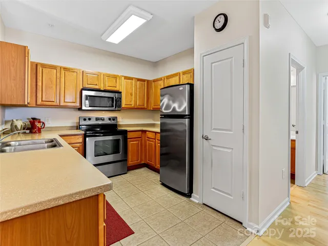 a kitchen with a refrigerator stove and sink