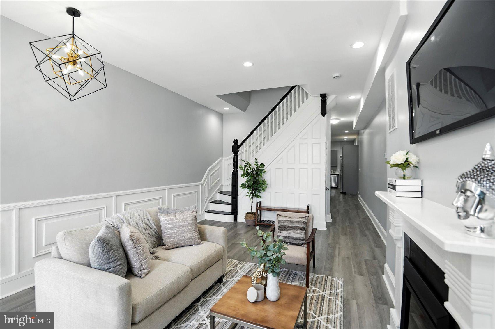 1628 East Biddle Street Baltimore, MD 21213 - Photo 1 of 35 a living room with furniture and a chandelier