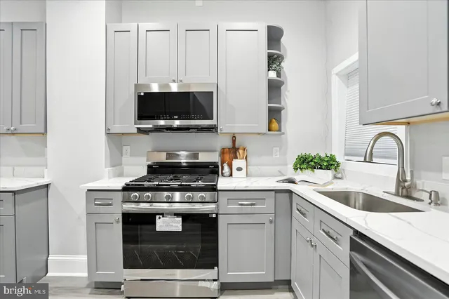 a kitchen with granite countertop a stove and a sink