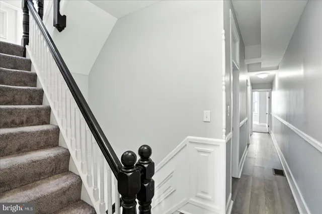 a view of entryway and hall with wooden floor