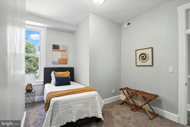 a bedroom with a bed and a window