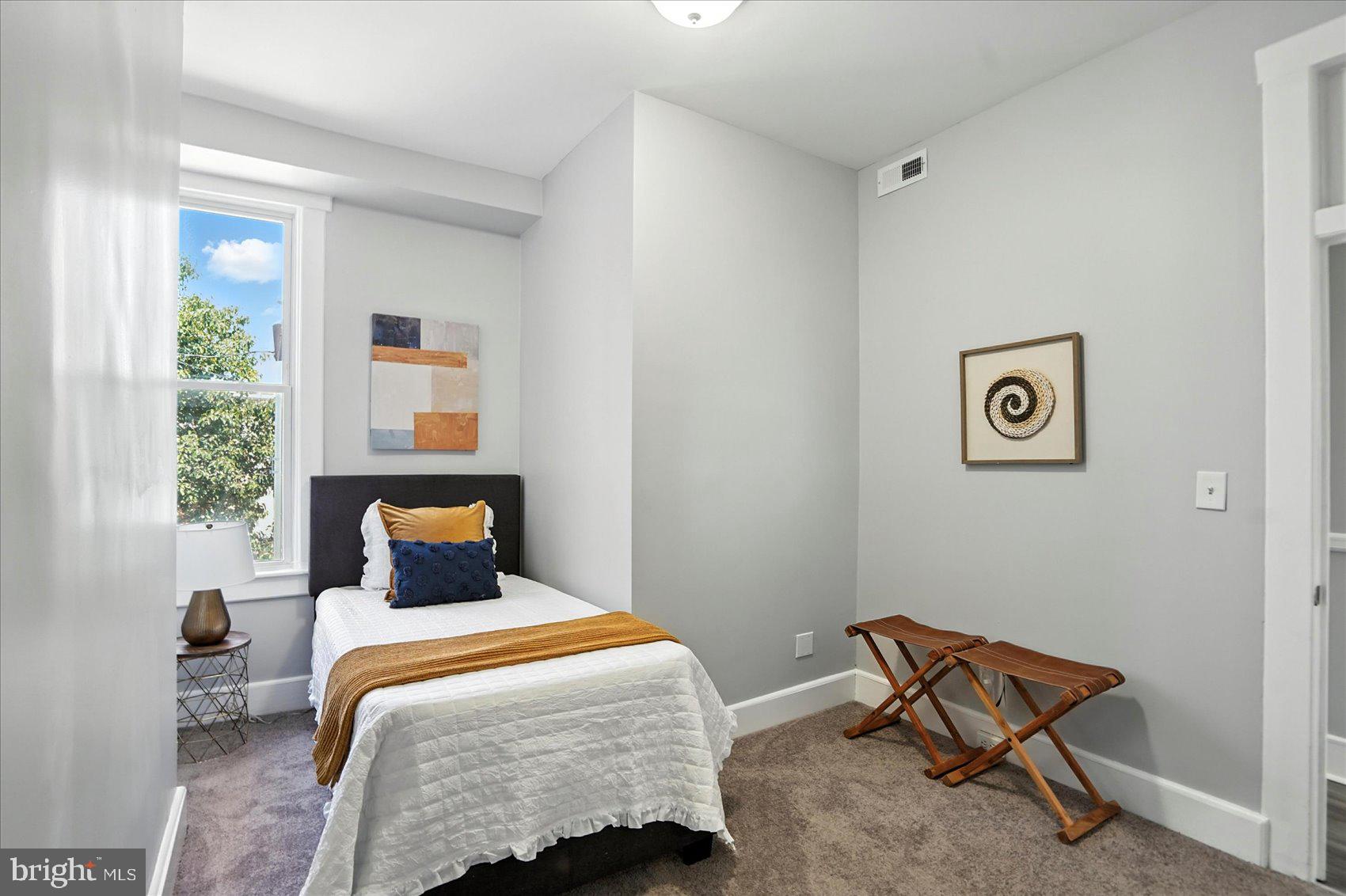 1628 East Biddle Street Baltimore, MD 21213 - Photo 17 of 35 a bedroom with a bed and a window