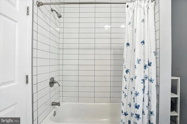 a bathroom with a bathtub and shower