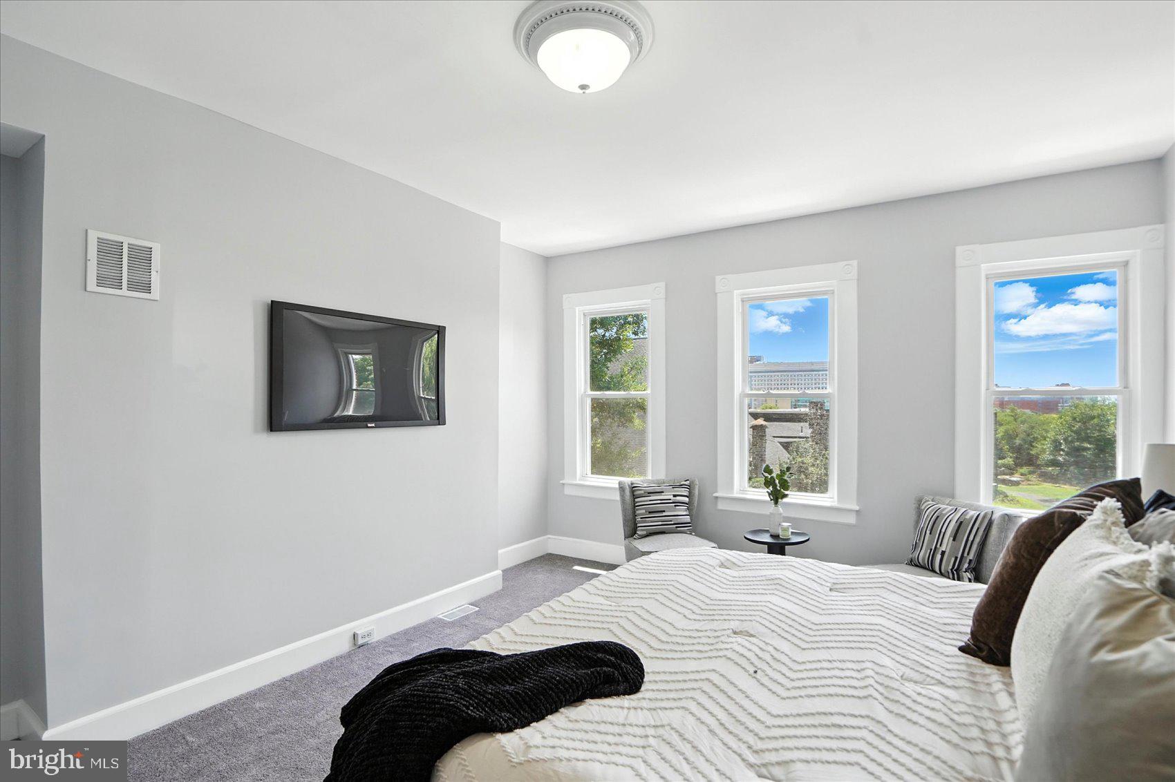 1628 East Biddle Street Baltimore, MD 21213 - Photo 26 of 35 a bedroom with a bed and a window