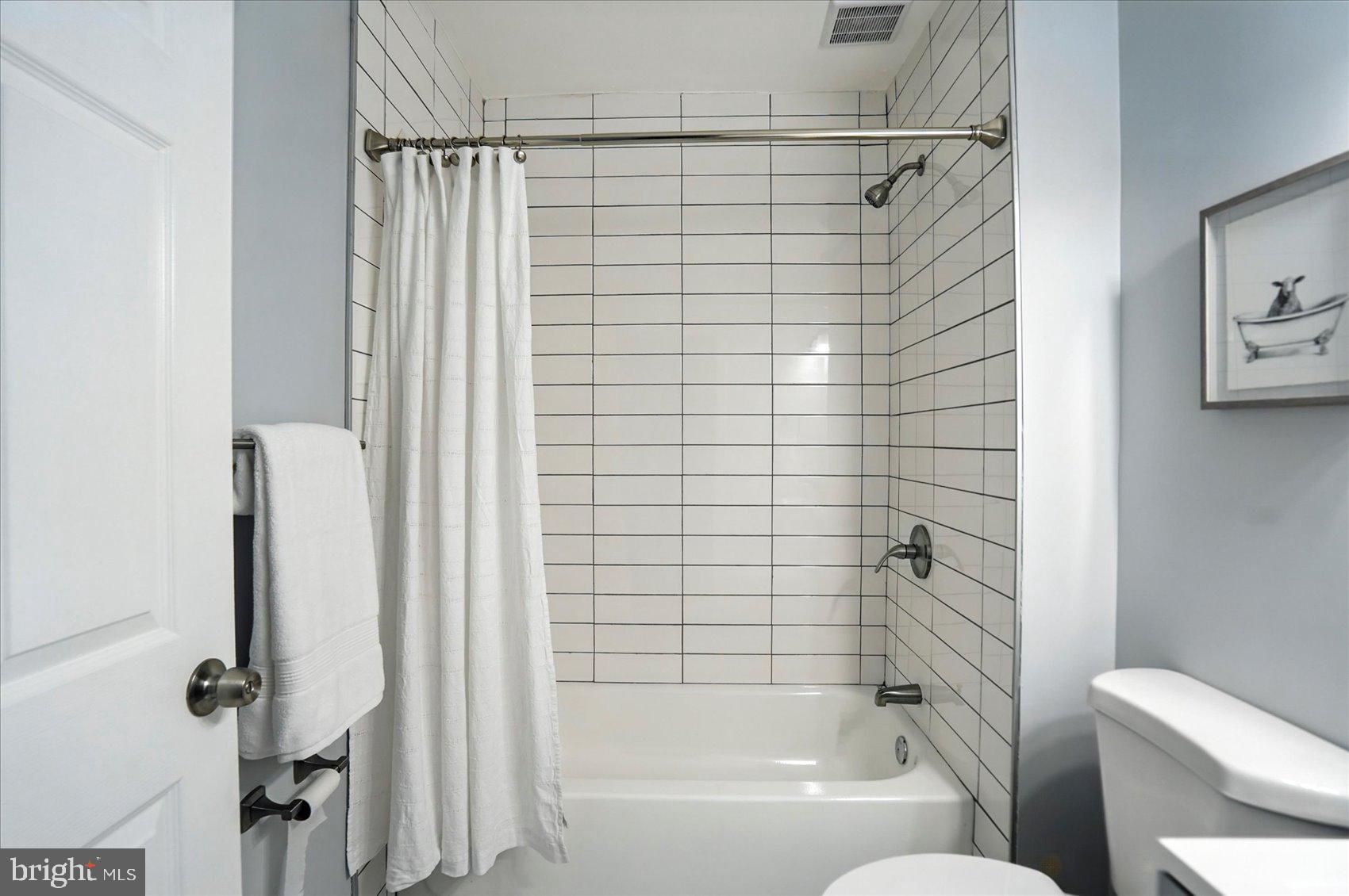 1628 East Biddle Street Baltimore, MD 21213 - Photo 29 of 35 a bathroom with a shower and a toilet