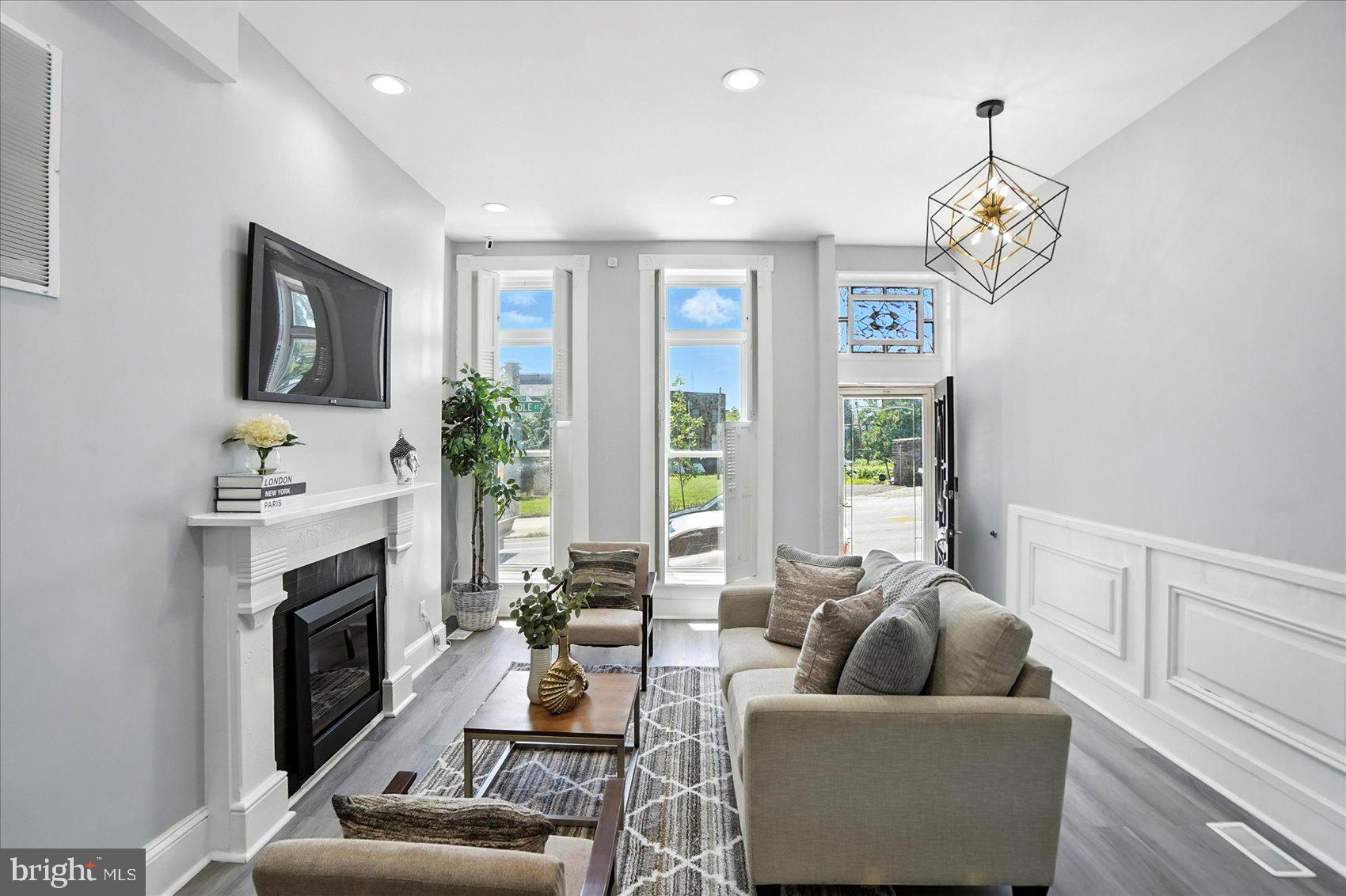 1628 East Biddle Street Baltimore, MD 21213 - Photo 3 of 35 a living room with furniture fireplace and a flat screen tv