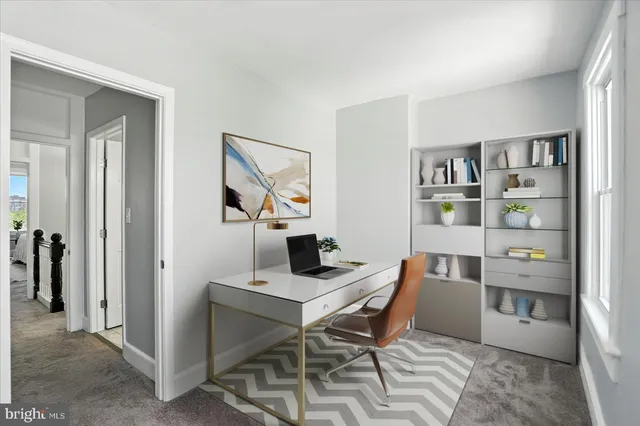 a view of a workspace with furniture and closet