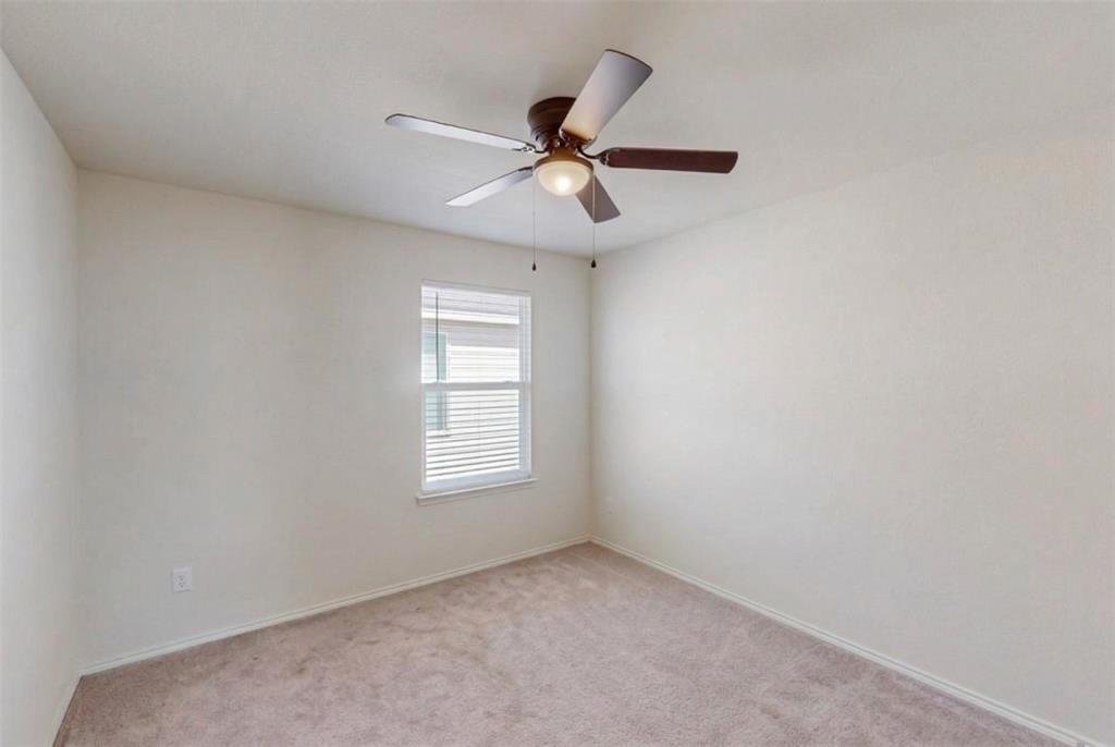 1103 Brazoria Road Forney, TX 75126 - Photo 11 of 25 an empty room with windows and fan