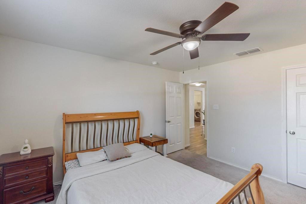 1103 Brazoria Road Forney, TX 75126 - Photo 18 of 25 a bedroom with a bed and a ceiling fan