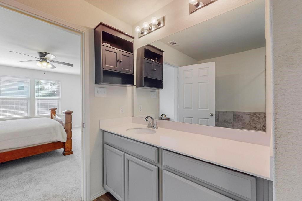 1103 Brazoria Road Forney, TX 75126 - Photo 22 of 25 a en suite bathroom with a sink and a mirror
