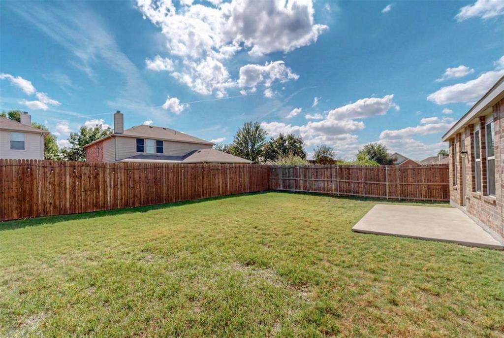 1103 Brazoria Road Forney, TX 75126 - Photo 23 of 25 a view of a backyard with wooden fence
