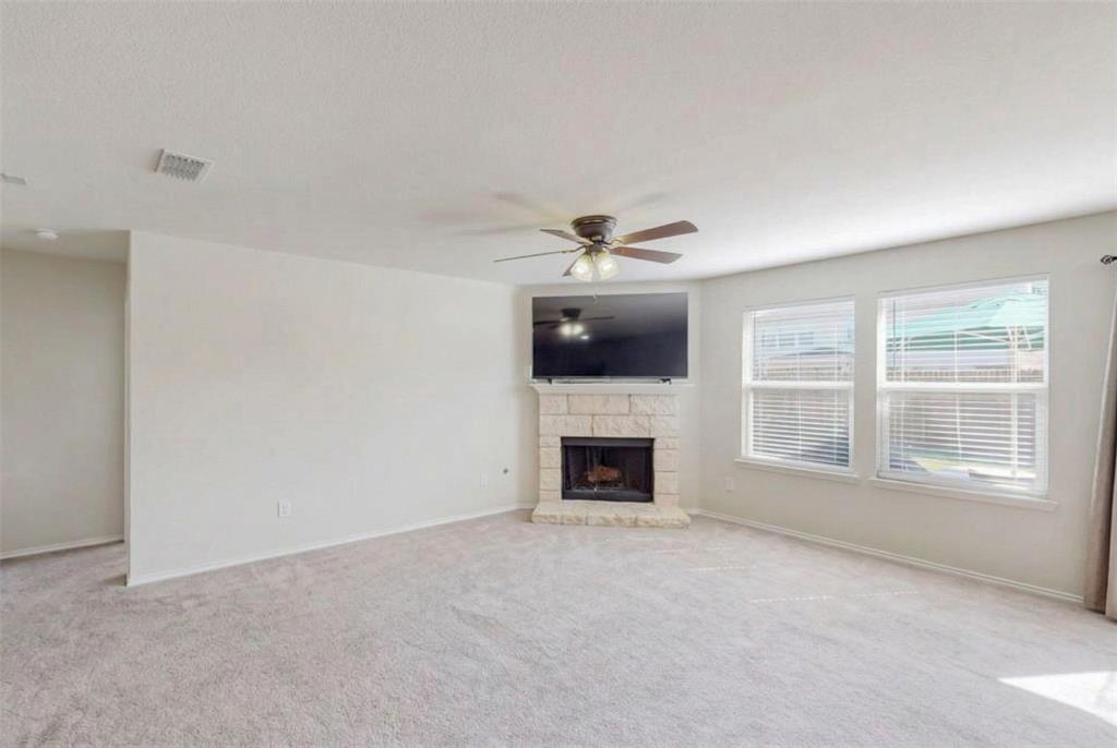 1103 Brazoria Road Forney, TX 75126 - Photo 3 of 25 a view of an empty room with chandelier fan and fire place