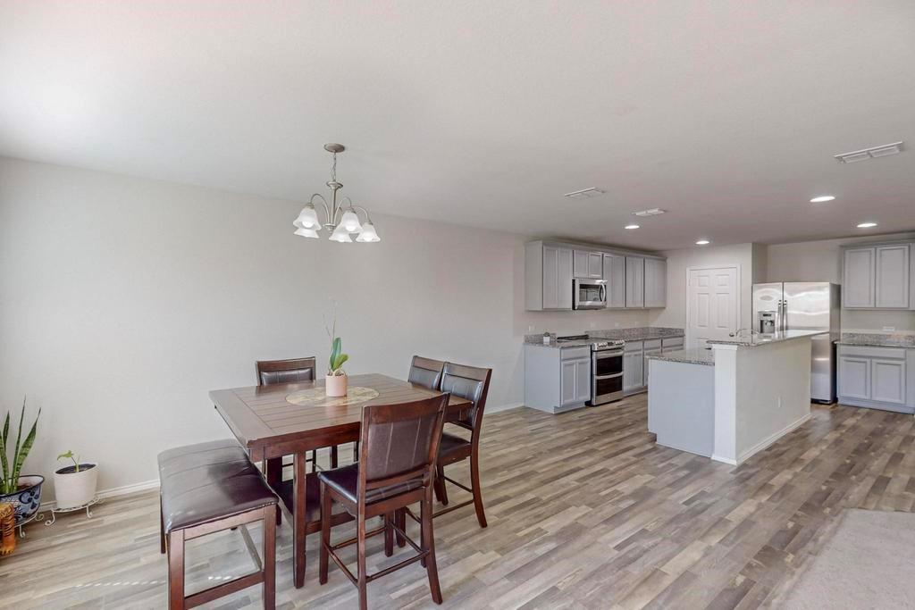 1103 Brazoria Road Forney, TX 75126 - Photo 6 of 25 a view of a dining room with furniture and wooden floor