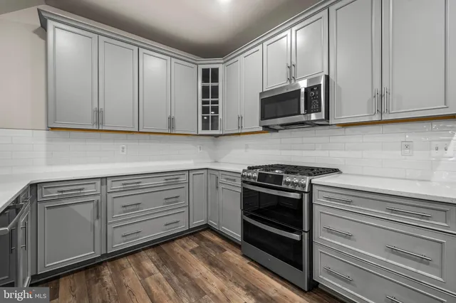 a bedroom with a bed a rug and ceiling fan