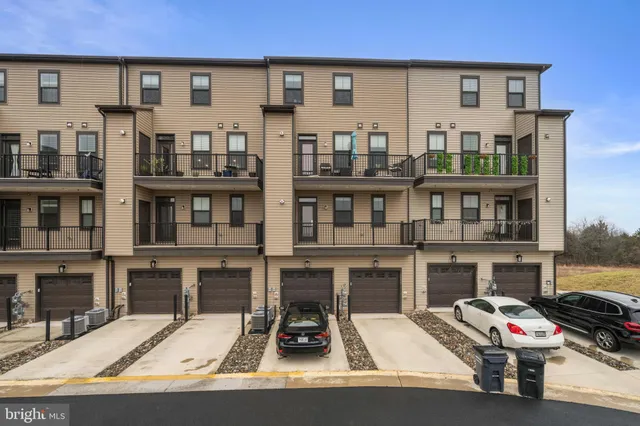a living room with furniture a flat screen tv and a floor to ceiling window
