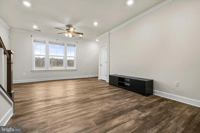 a view of kitchen with wooden floor and electronic appliances