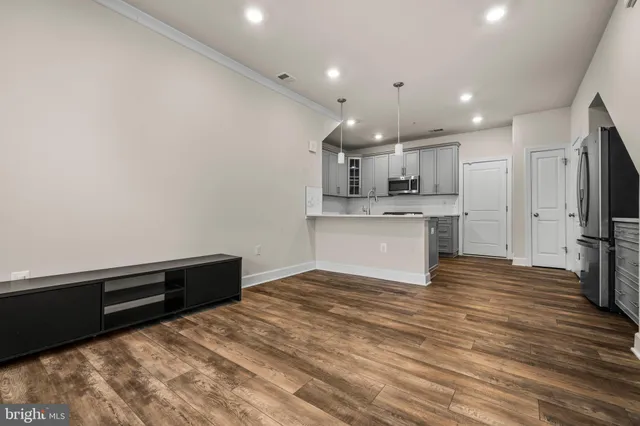 a view of kitchen with wooden floor and electronic appliances