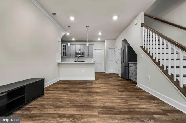 a kitchen with a sink window and cabinets