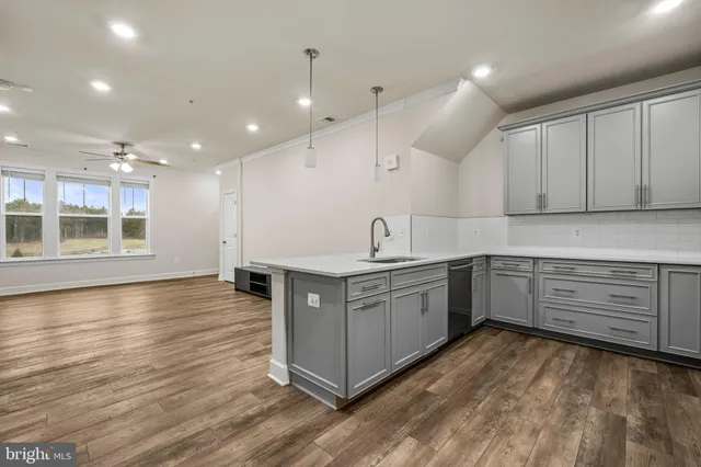 a kitchen with stainless steel appliances granite countertop a stove and a sink