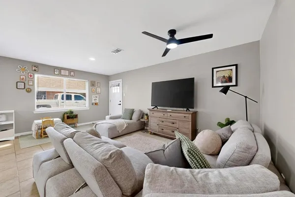 a living room with furniture and a flat screen tv