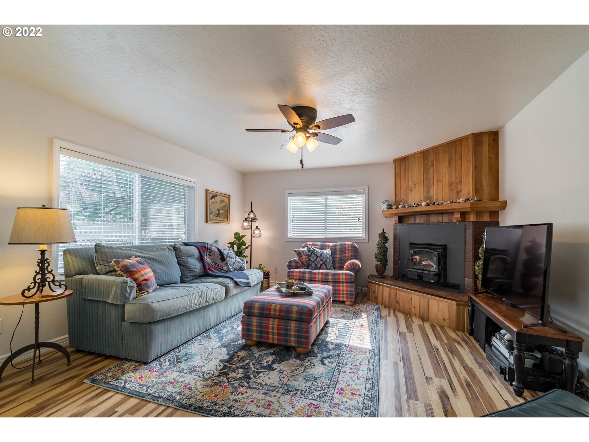 86710 Bailey Hill Road Eugene, OR 97405 - Photo 5 of 32 a living room with furniture a fireplace and a flat screen tv