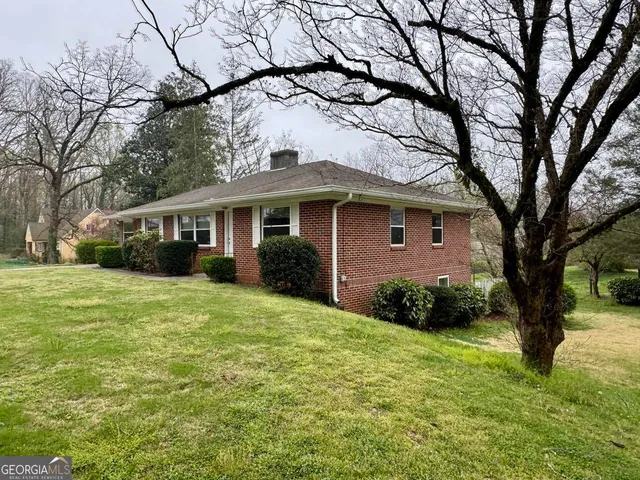 a yellow house in middle of the forest
