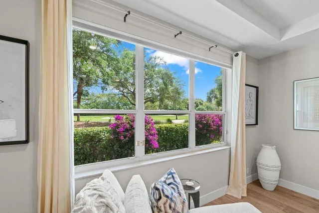 a spacious bathroom with a granite countertop sink a toilet and a mirror