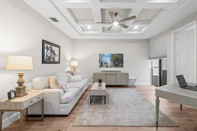 a living room with furniture and a wooden floor