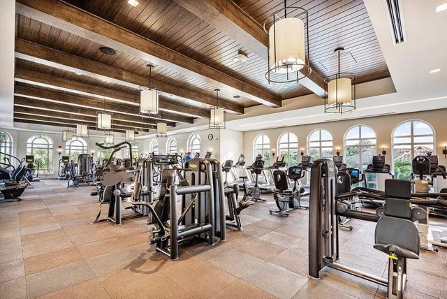 a view of a patio with table and chairs potted plants and palm trees