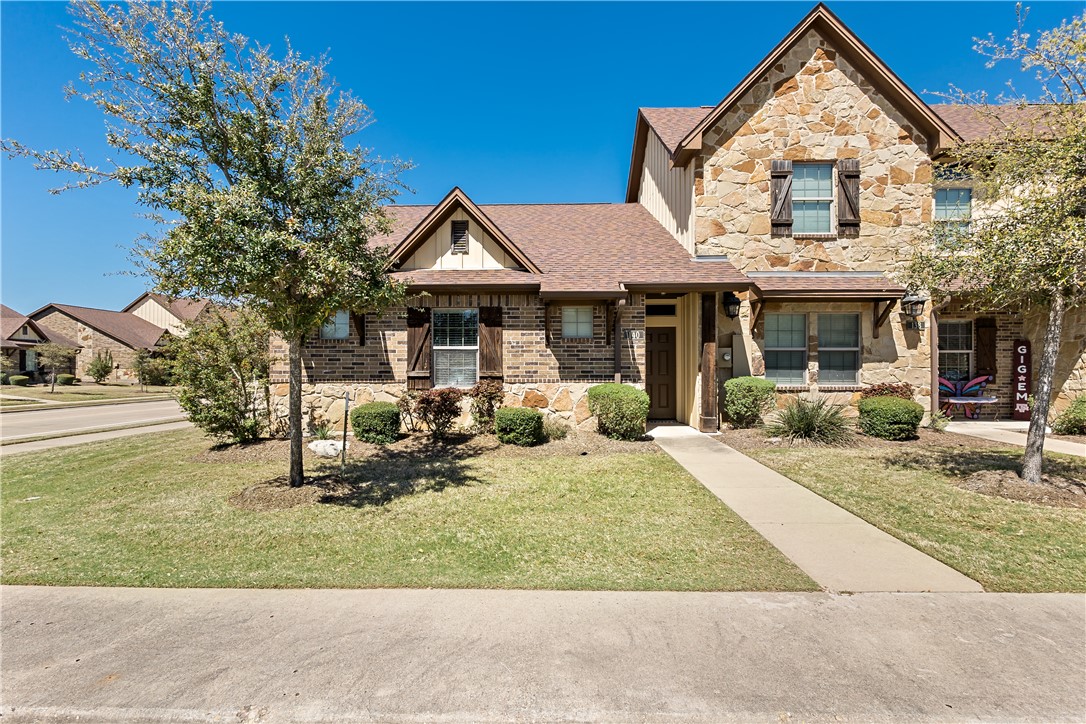 a front view of a house with garden