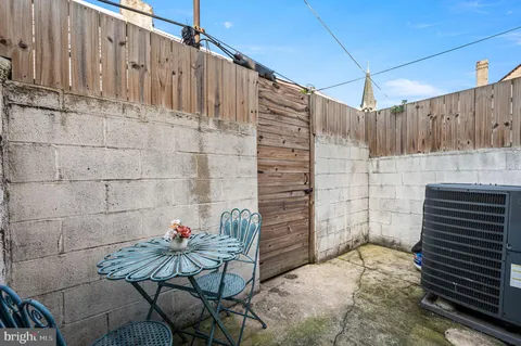 a view of wooden door and chair under an umbrella