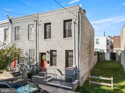 a view of a patio with couches table and chairs and potted plants