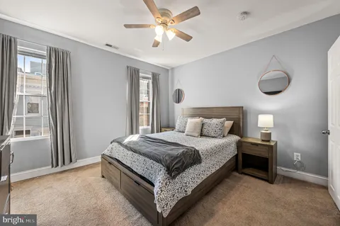 a large bedroom with a bed and a chandelier