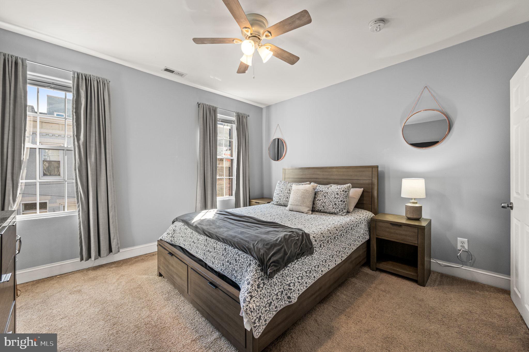 1813 Fernon Street Philadelphia, PA 19145 - Photo 7 of 16 a large bedroom with a bed and a chandelier