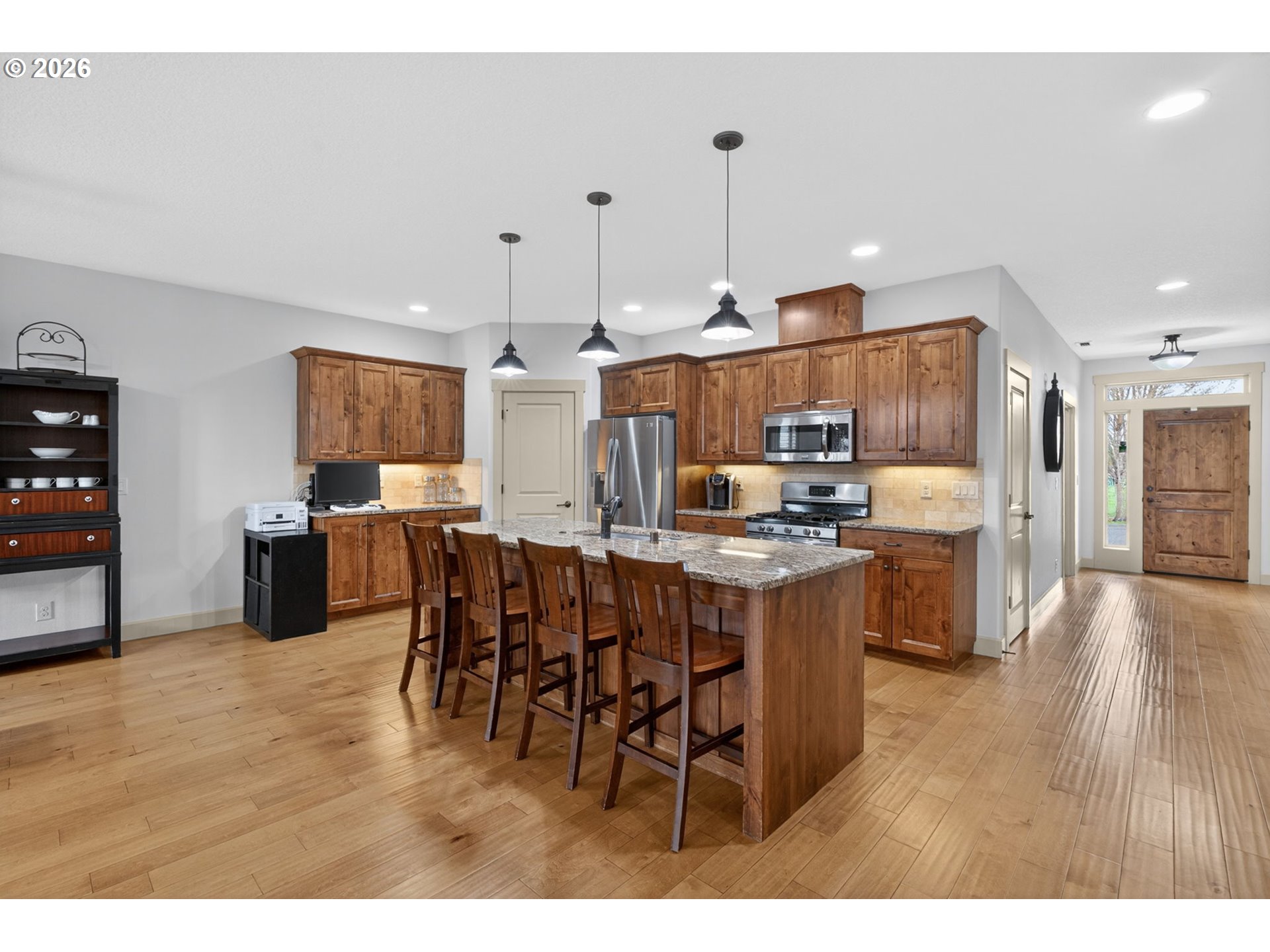 2003 Northwest 17th Street Battle Ground, WA 98604 - Photo 5 of 30 a open kitchen with stainless steel appliances kitchen island granite countertop a table chairs and a refrigerator