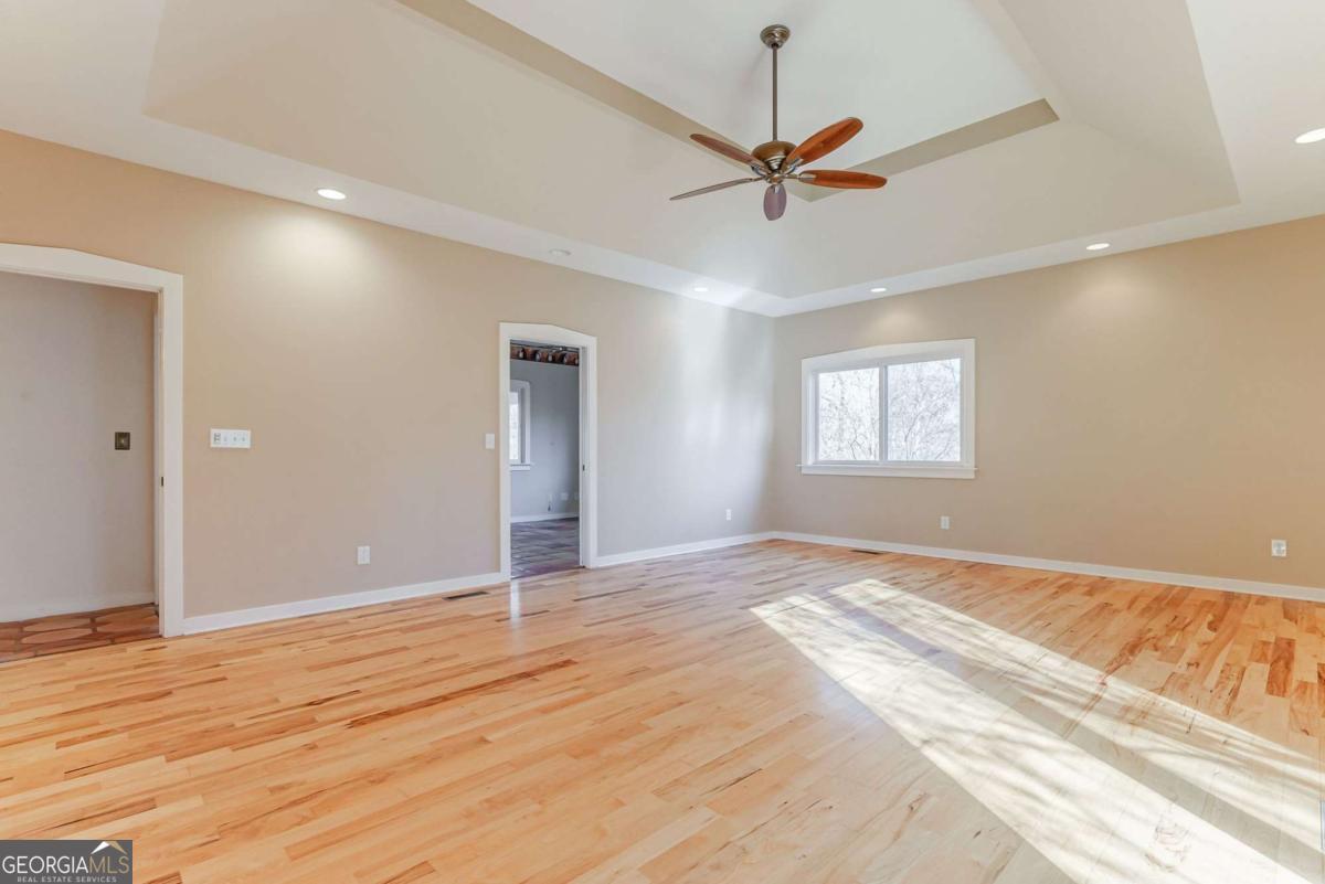 2223 Salem Road Watkinsville, GA 30677 - Photo 22 of 63 a view of an empty room with wooden floor and a window