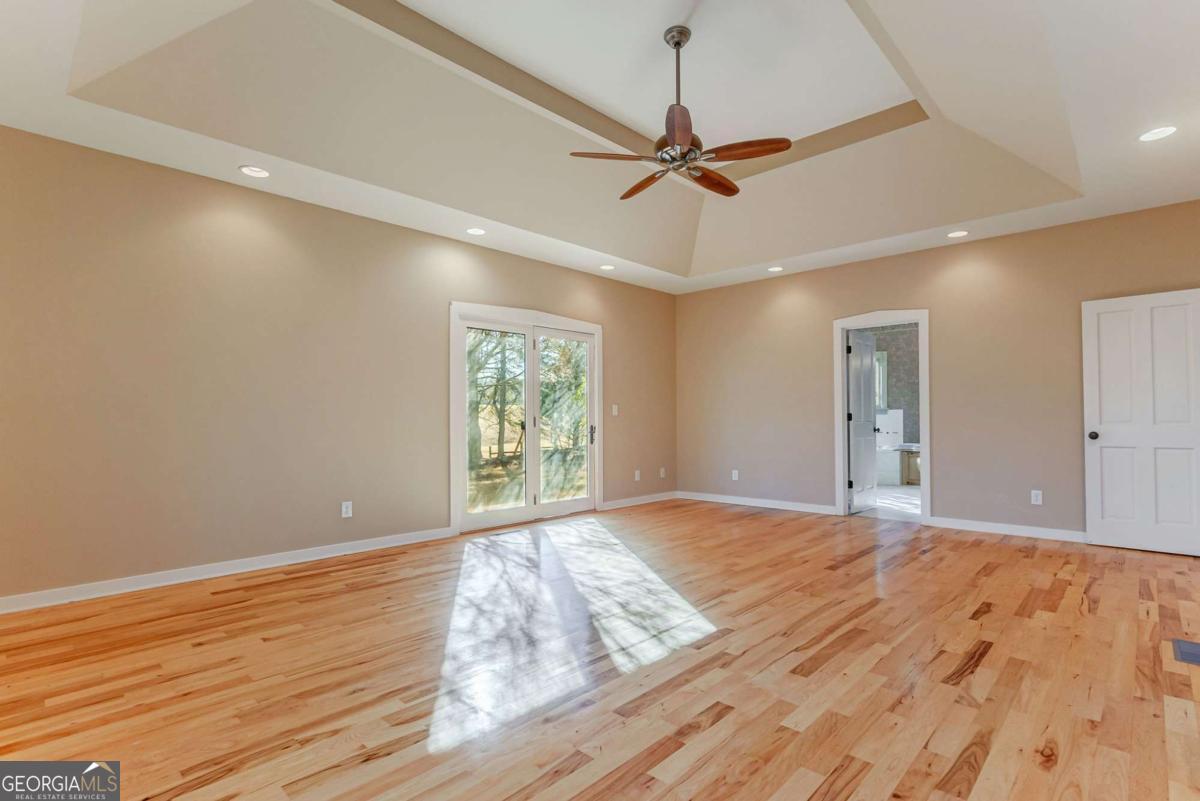 2223 Salem Road Watkinsville, GA 30677 - Photo 23 of 63 a view of an empty room and window a ceiling fan and wooden floor