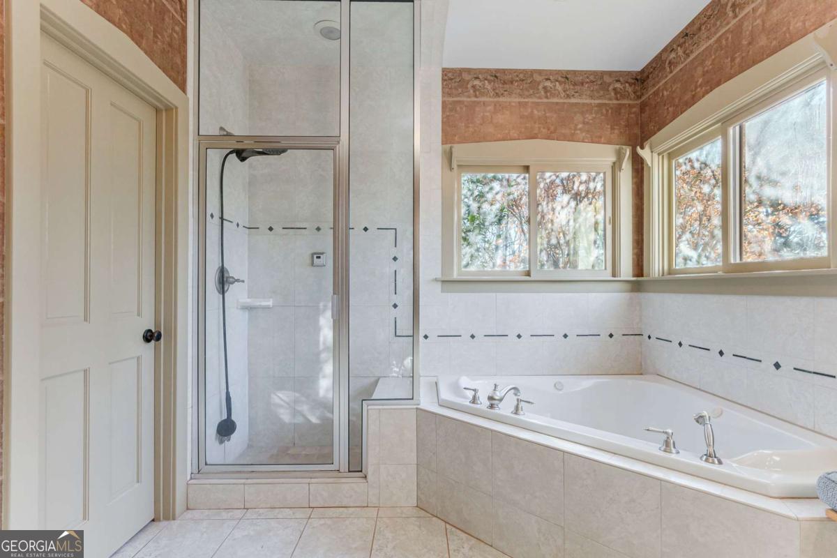 2223 Salem Road Watkinsville, GA 30677 - Photo 24 of 63 a bathroom with a bathtub and shower