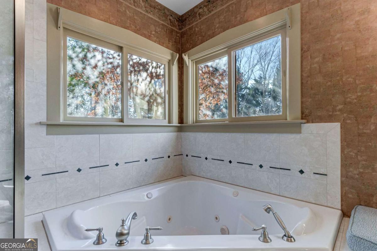2223 Salem Road Watkinsville, GA 30677 - Photo 25 of 63 a bathroom with a bathtub and window
